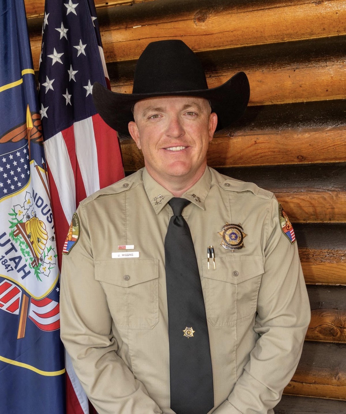 Sheriff Jamison Wiggins of Grand County, Utah in uniform beside the American flag
